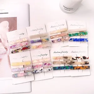 Set of 3 colorful acetate hair clips with marble patterns for women on a white card
