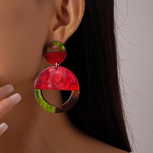Detailed close-up of geometric acrylic earrings with colorful marble texture on a model