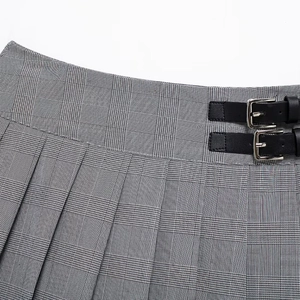 Gray plaid pleated mini skirt with black leather buckle details and classic checkered pattern