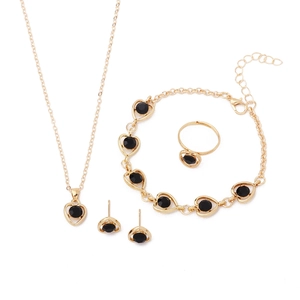 Elegant gold jewelry set with black heart-shaped crystals: necklace, bracelet, ring, earrings