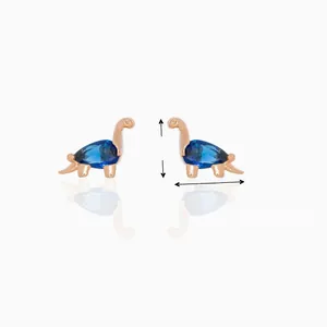 Detail view of dinosaur stud earring with blue teardrop gemstone and rose gold frame