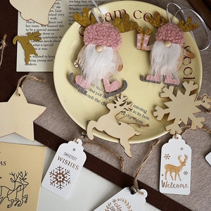 Detailed view of pink knitted gnome ski ornaments and rustic wooden Christmas hanging tags