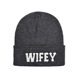Close-up of WIFEY white plush lettering on a dark grey ribbed knit beanie hat