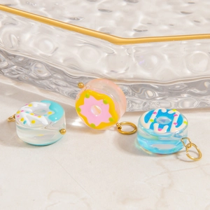 Donut shaped glass pendants in pink and blue with gold plated stainless steel loops