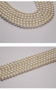Detailed view of high-luster round cream white imitation pearls for jewelry making