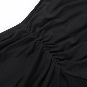 Detail of black pleated high-stretch fabric with delicate knit texture and fine stitching