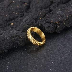 Macro shot of gold punk snake scale ring showing textured surface and brushed inner band