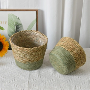 Detail of handwoven seagrass planter with green color blocking and waterproof inner liner
