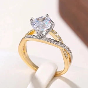Macro shot of two-tone twisted band engagement ring with a round four-prong solitaire