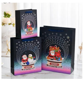 Detailed view of 3-piece Christmas gift bags with colorful Santa motifs and satin handles