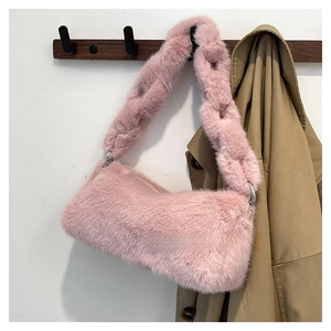 Detail of pink faux fur shoulder bag with soft plush texture and silver metal hardware