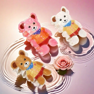 Three cute acrylic teddy bear hair claws on pink wavy background with rose flower