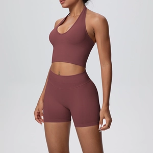 Macro detail of seamless ribbed knit fabric on halter yoga top and high-waist shorts