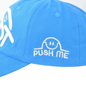 Close-up of blue baseball cap featuring high-quality white 3D embroidery and text