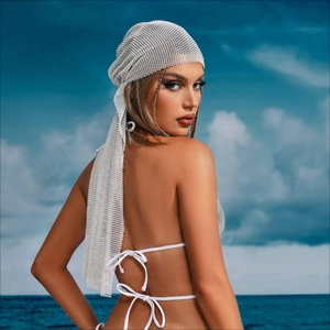 Sparkly rhinestone mesh headscarf for women with fringe details on a sunny beach background
