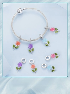 Detail of S925 silver bracelet with color-changing crystal rose charms and leaf accents