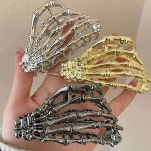 Skeleton hand claw hair clips in silver, gold and black metallic finishes for women