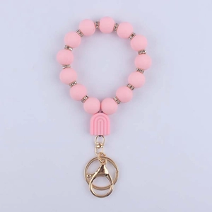 Detail of pink silicone beads keychain with glitter spacers and gold lobster clasp