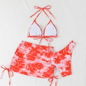 Three-piece women's halter bikini set with red floral print and drawstring mini skirt