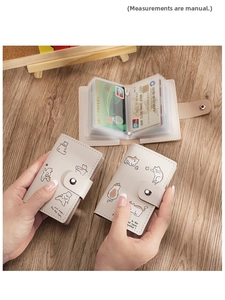 Detailed view of the cute cat cartoon card holder showing accordion-style slots and snap button