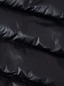 Macro view of black glossy waterproof fabric with quilted texture and fine stitching
