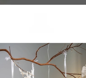 Detail of a white glitter reindeer Christmas ornament with a translucent silk hanging ribbon