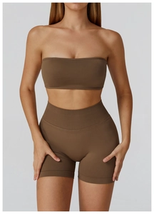 Detail view of coffee brown seamless ribbed sports bandeau and high-waist biker shorts