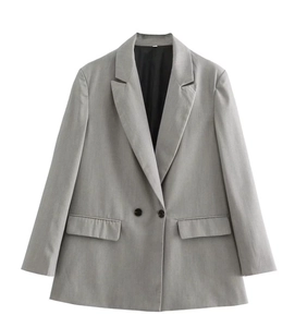 Close-up detail of grey double-breasted blazer showing fabric texture and lapel design