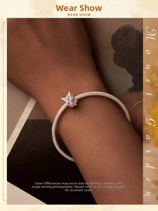 Close-up of S925 sterling silver mesh bracelet with a pink butterfly charm on a wrist