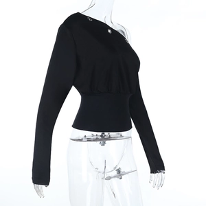 Detail of off-shoulder black sweatshirt featuring metal eyelets and a cinched waist design