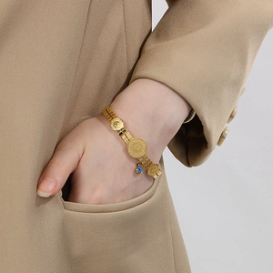 Fashionable gold watch-band style bracelet with coin pendants and evil eye charm