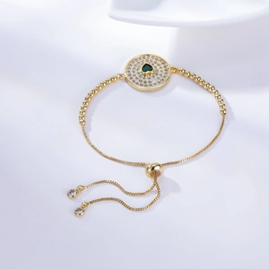 Gold adjustable bracelet with heart green gemstone and white zircon pavé details