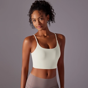 Detailed back view of an ivory yoga crop top with thin straps and a form-fitting design