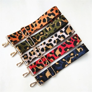 Close-up of colorful leopard print bag straps with golden adjustable metal buckles