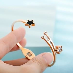 Rose gold open star bracelet with black and crystal charms and spring clasp