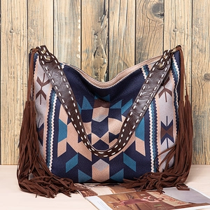 Detail view of Bohemian woven tote bag with fringe accents and rustic geometric patterns