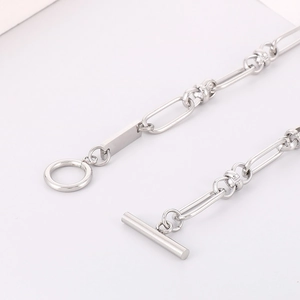 Macro detail of silver titanium steel paperclip chain with toggle OT clasp closure