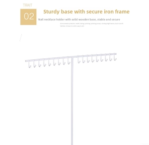 Detail of white iron T-bar necklace holder with hooks and a solid wood base for jewelry