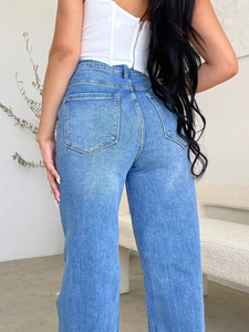 Rear view of high waist dark blue denim jeans showing fit, pockets and washed texture