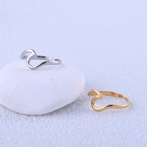 Close-up of minimalist gold and silver wavy stackable rings with an adjustable open design