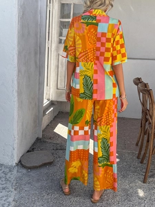 Rear view of vibrant bohemian set with tropical leaf and geometric patchwork patterns