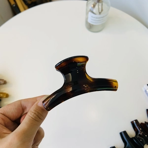 Detail shot of the glossy amber tortoise shell hair claw clip with acetate texture