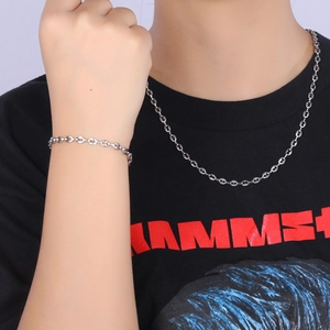 Detail of 4.5mm silver stainless steel coffee bean link chain bracelet and necklace on model