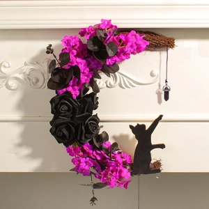 Macro shot of crescent moon wreath with black cat silhouette and purple pendant