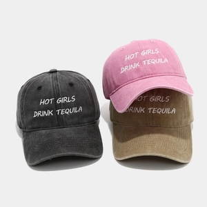Detail of washed cotton baseball caps with embroidered HOT GIRLS DRINK TEQUILA text