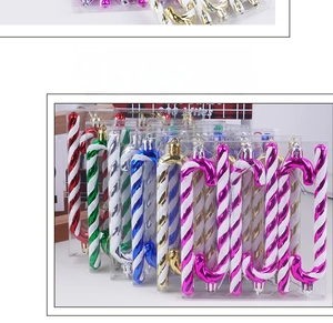 Close-up of colorful striped Christmas candy cane ornaments in various festive metallic shades