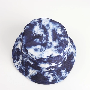 Detailed view of tie-dye bucket hat with reinforced stitching and dark blue ink pattern