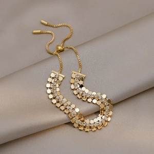 Bracciale regolabile in oro con paillettes e strass scintillanti su seta