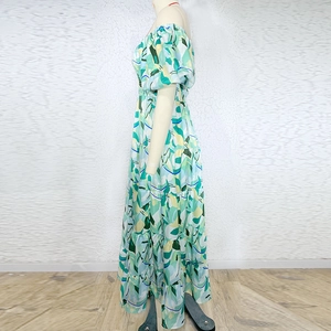 Detail view of floral off-shoulder maxi dress with tiered skirt and puff sleeves