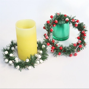 Artificial Christmas candle ring wreath with snow berries and green pine needles decoration